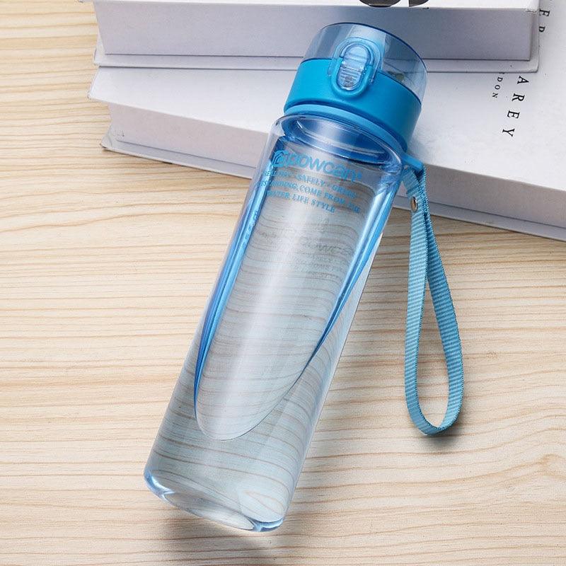 a toothbrush sitting on a table next to a bottle of water 