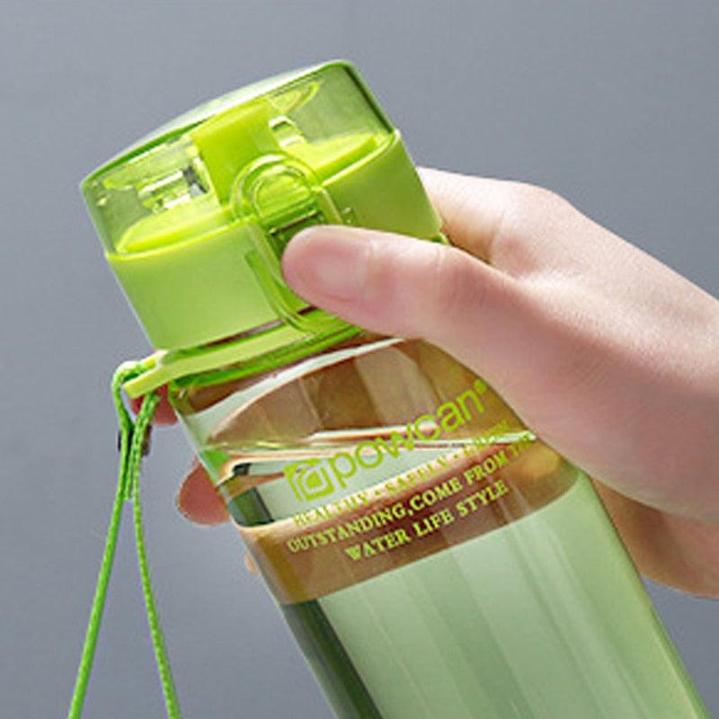 a person holding a green cell phone in their hand