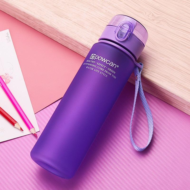 a purple toothbrush laying on a pink cloth 