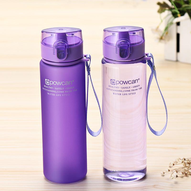a purple bottle sitting next to a purple bottle