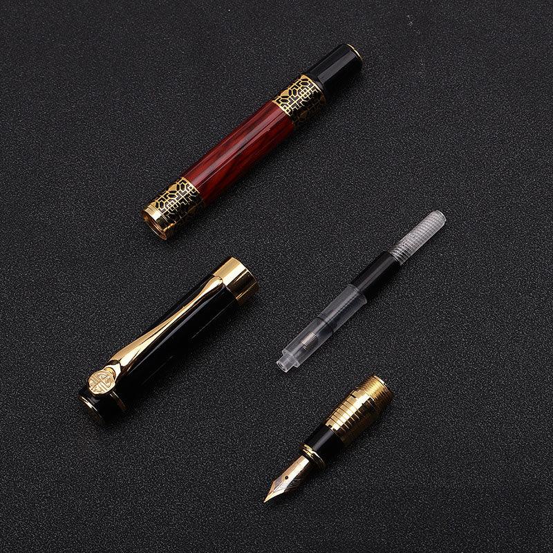 a pair of scissors and a pen on a black surface
