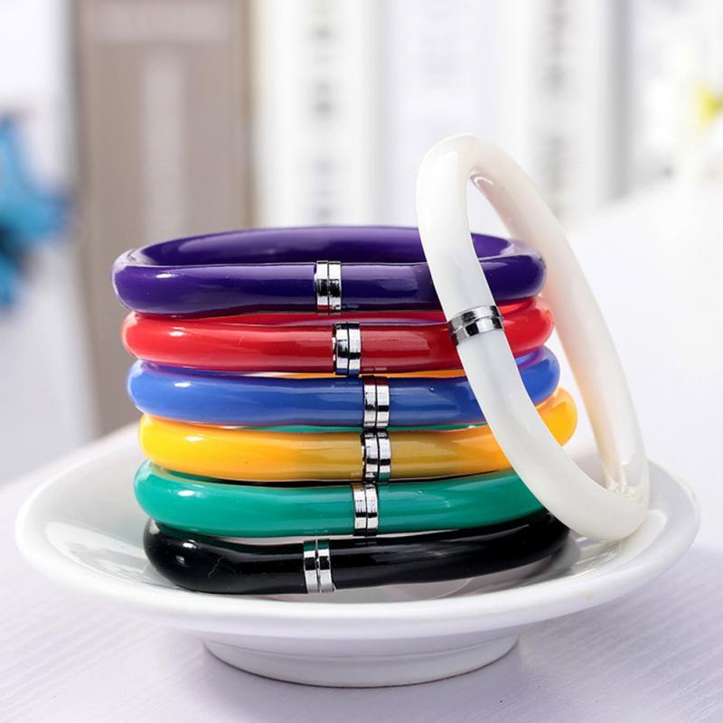 a close up of a colorful toothbrush on a plate 