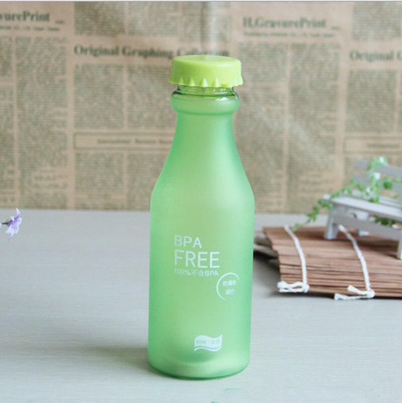 a green bottle sitting on a white table 