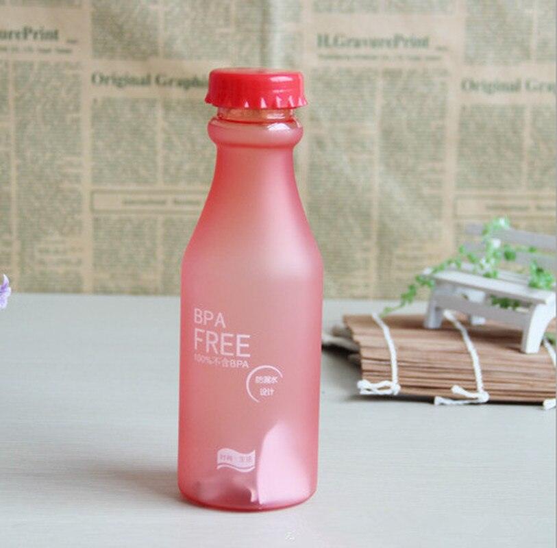 a red bottle sitting on top of a table 