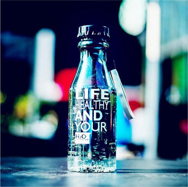 a bottle of alcohol sitting on top of a wooden table 