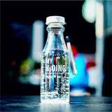 a bottle of water that is sitting on a table 