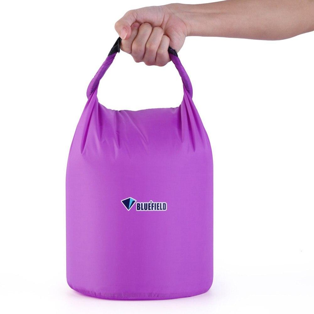 a woman in a purple dress holding a purple bag 
