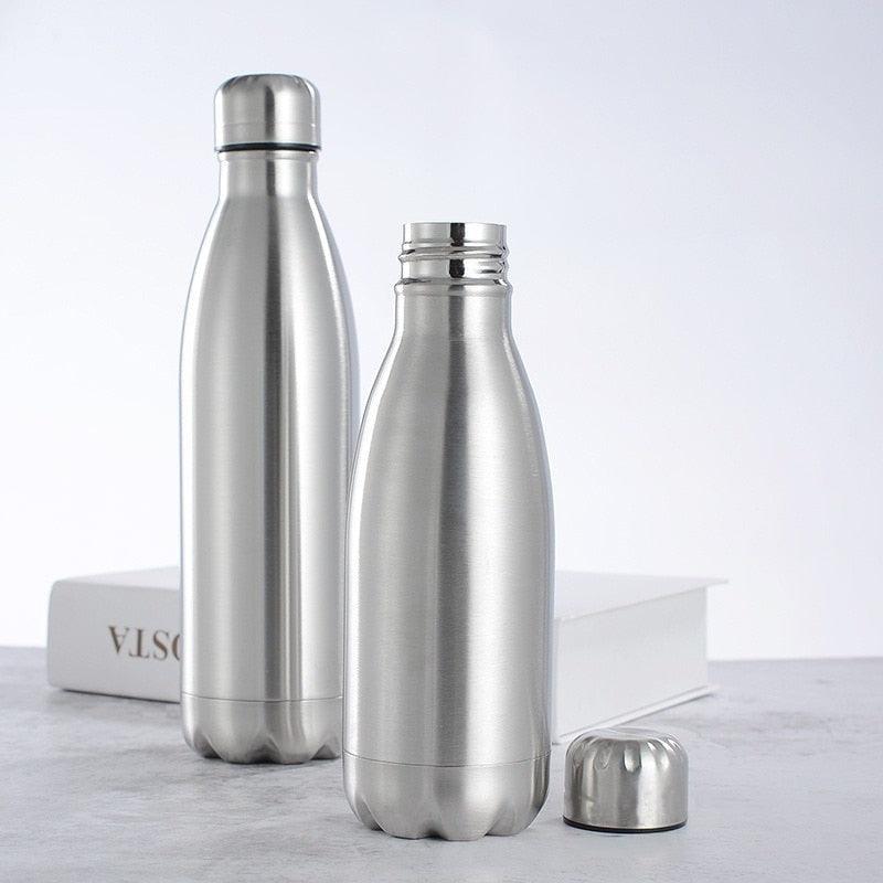 a group of three vases sitting on top of a table 