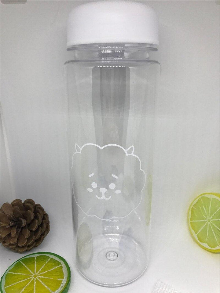 a glass bottle of water and a blender 