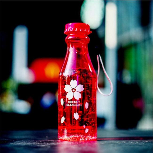 a red bottle sitting on top of a table 