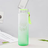 a green cup with a green liquid in it 