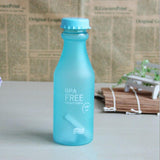 a blue bottle sitting on top of a table 