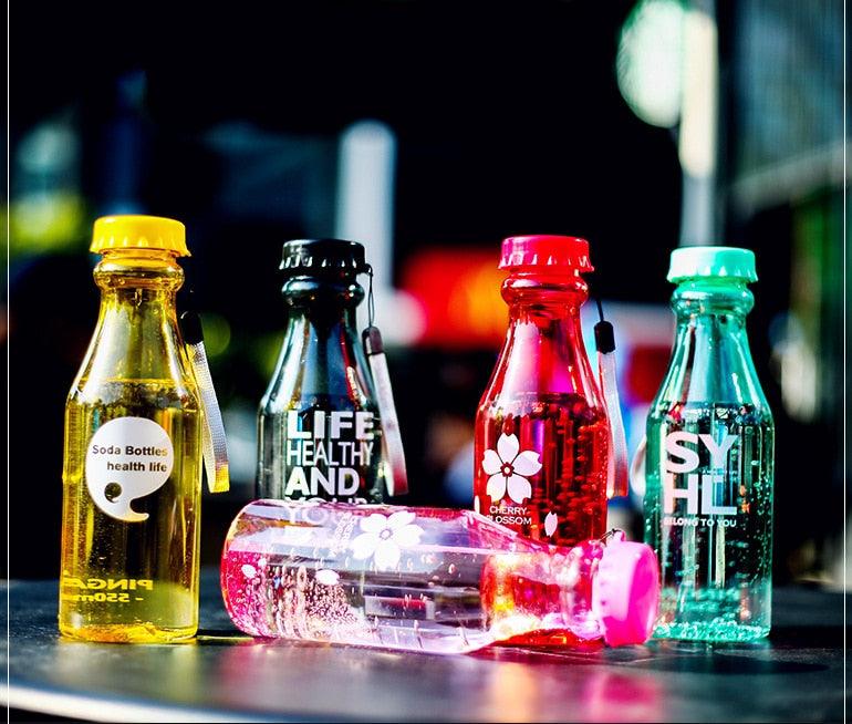 two bottles of alcohol sitting on top of a counter 