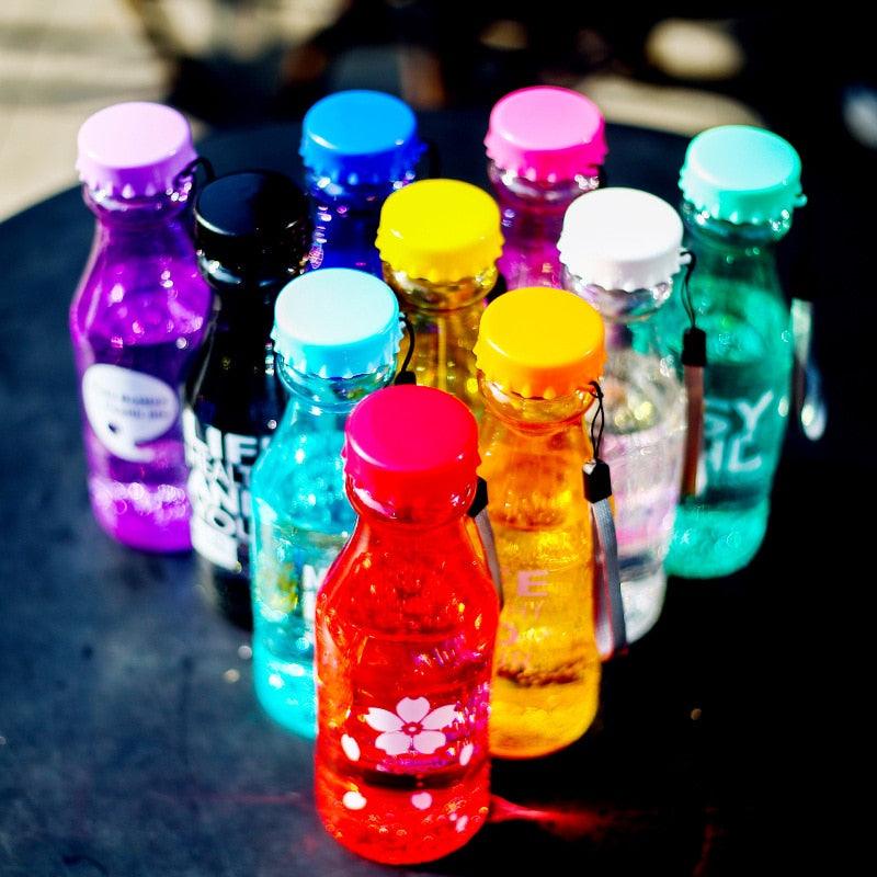 a close up of many different colored vases 