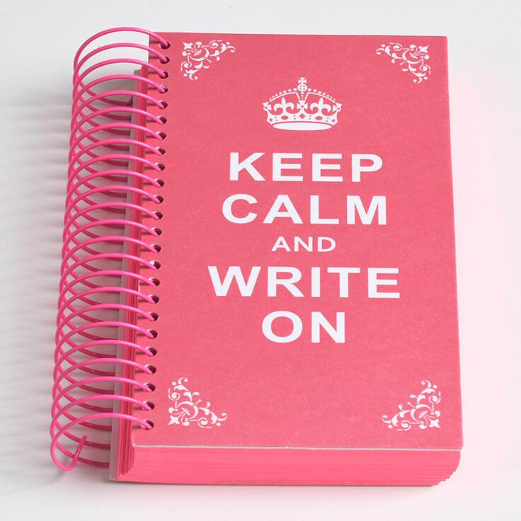 a close up of a red book on a pink suitcase 