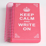 a close up of a red book on a pink suitcase 